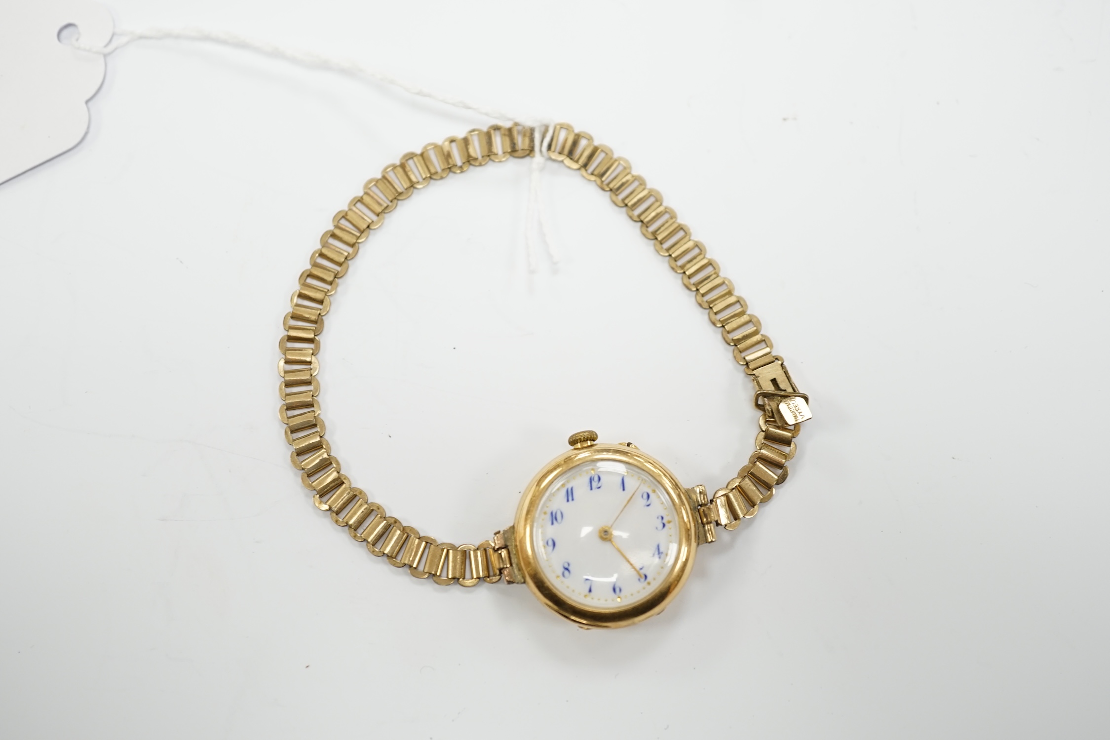 An early 20th century 15ct gold manual wind wrist watch, on a rolled gold bracelet.